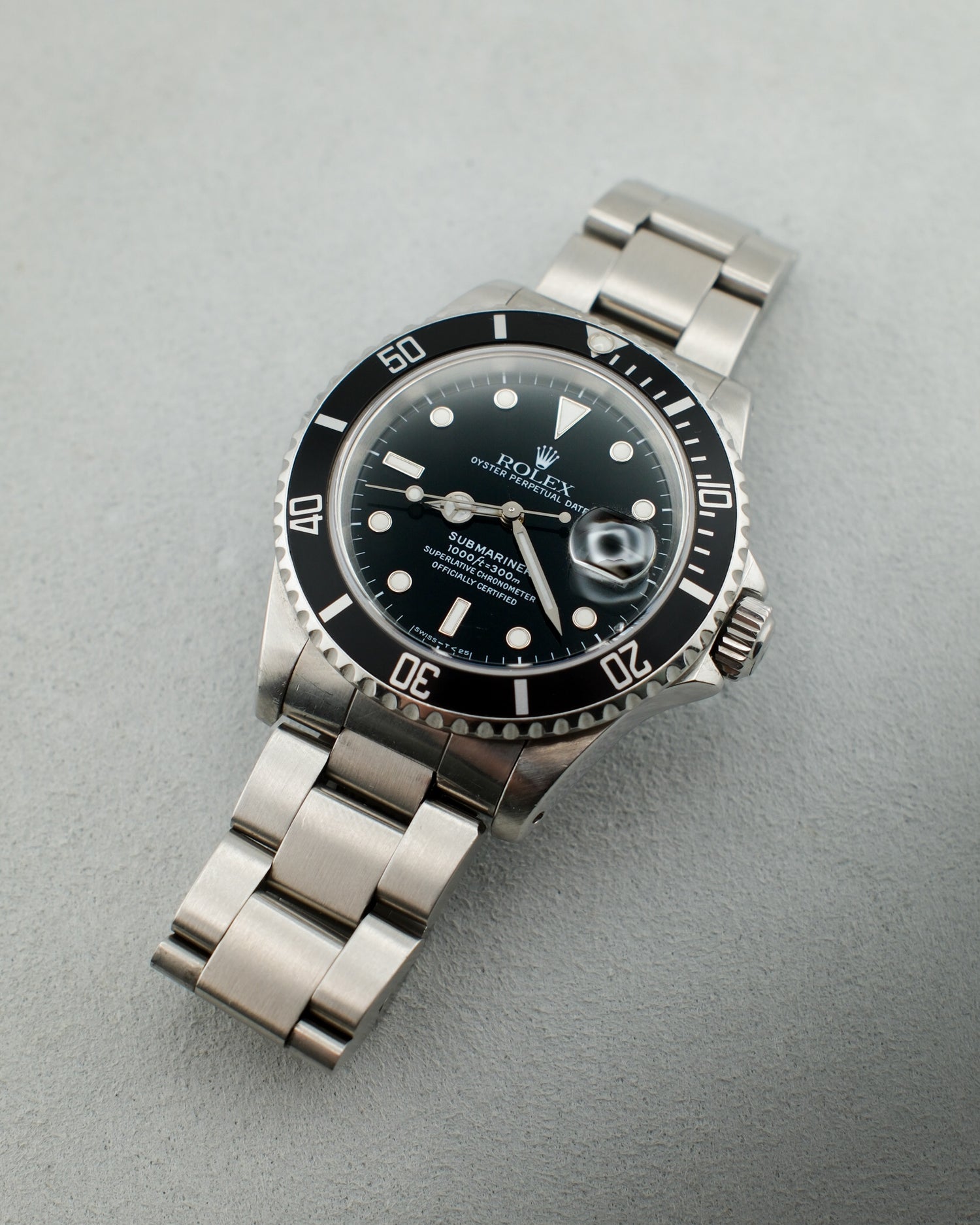 Steel watch with black dial. The iconic Rolex Submariner model.