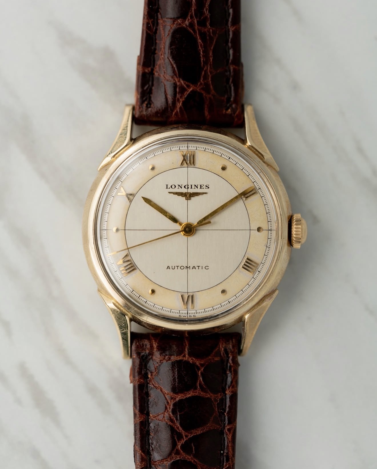 Vintage Longines automatic in yellow gold with Roman numerals on brown alligator strap