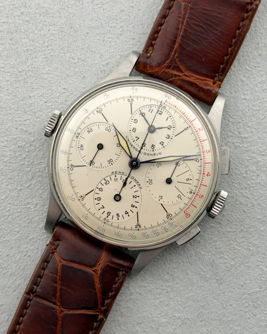 Vintage wristwatch with brown leather strap on a light gray background